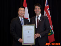 Paul Nguyen recieves the Newcomer Champion Award from Hon. Dr. Eric Hoskins, Ontario Minister of Citizenship and Immigration